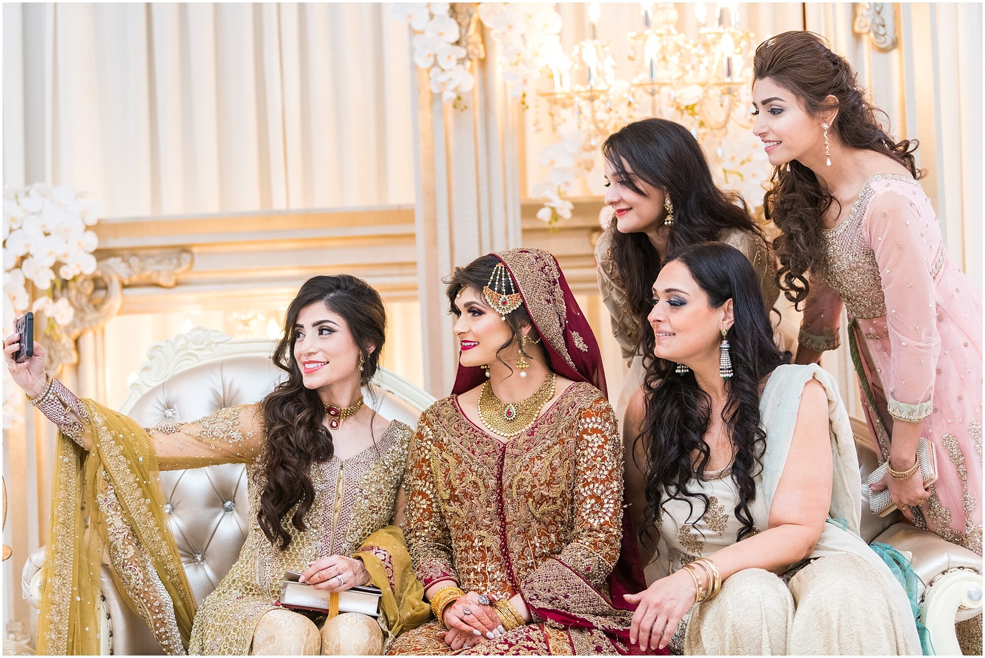 Pakistani bride taking a selfie with her friends at her wedding
