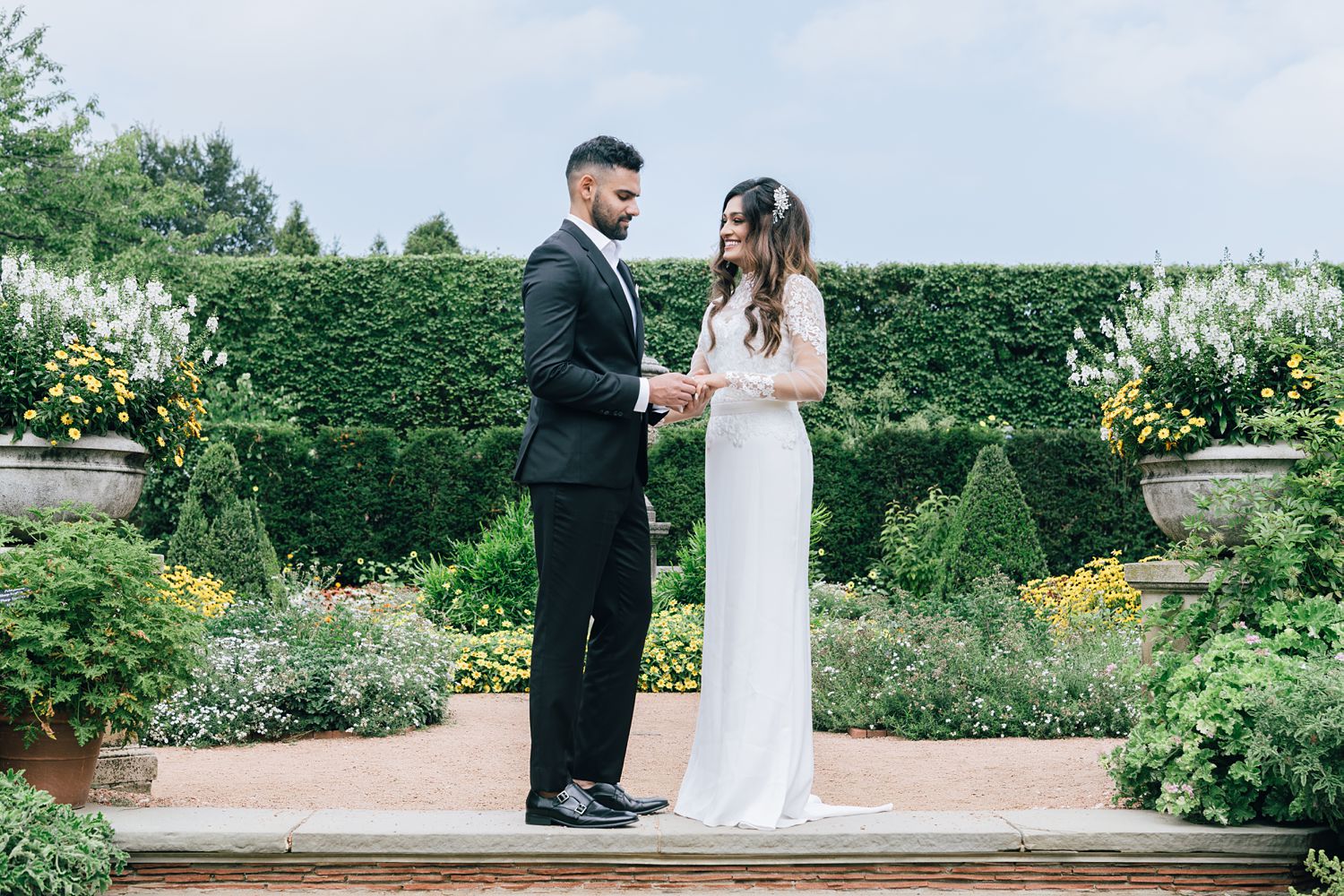 Wedding couple exchanging rings at Chicago Botanic Garden in the Walled English Garden