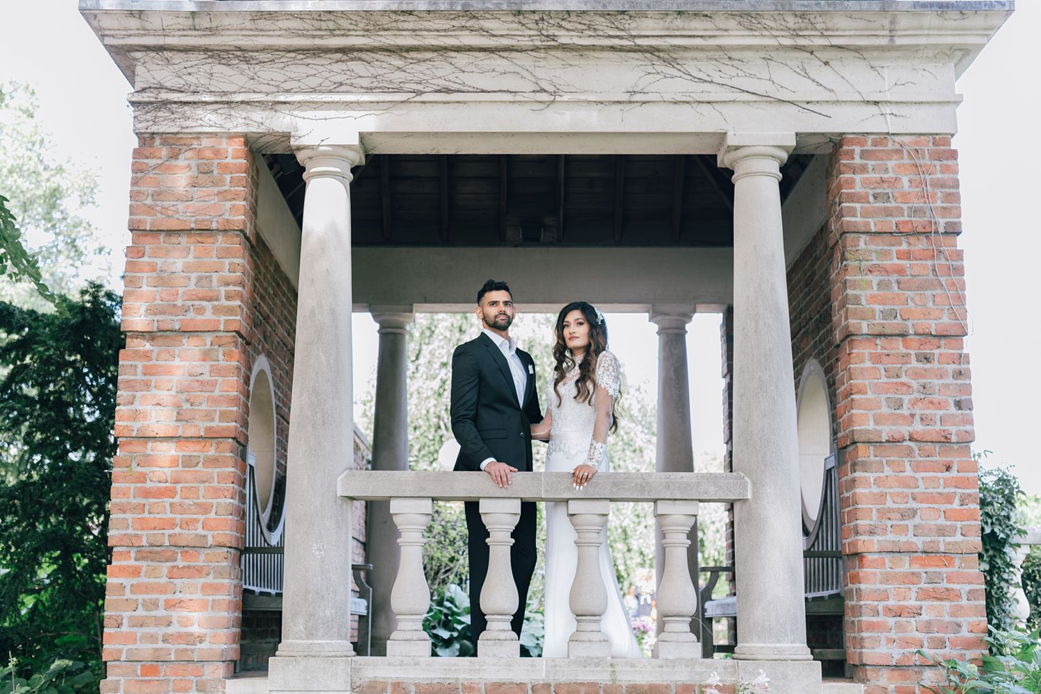 Wedding couple posing in archway at Chicago Botanic Garden for portrait