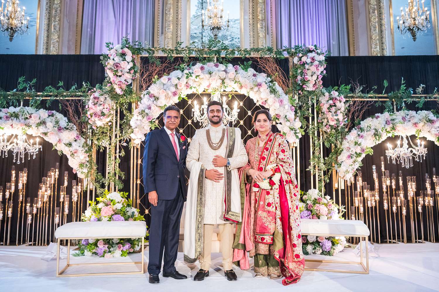 Pakistani Groom with his parents standing at wedding ceremony stage at Hilton Chicago