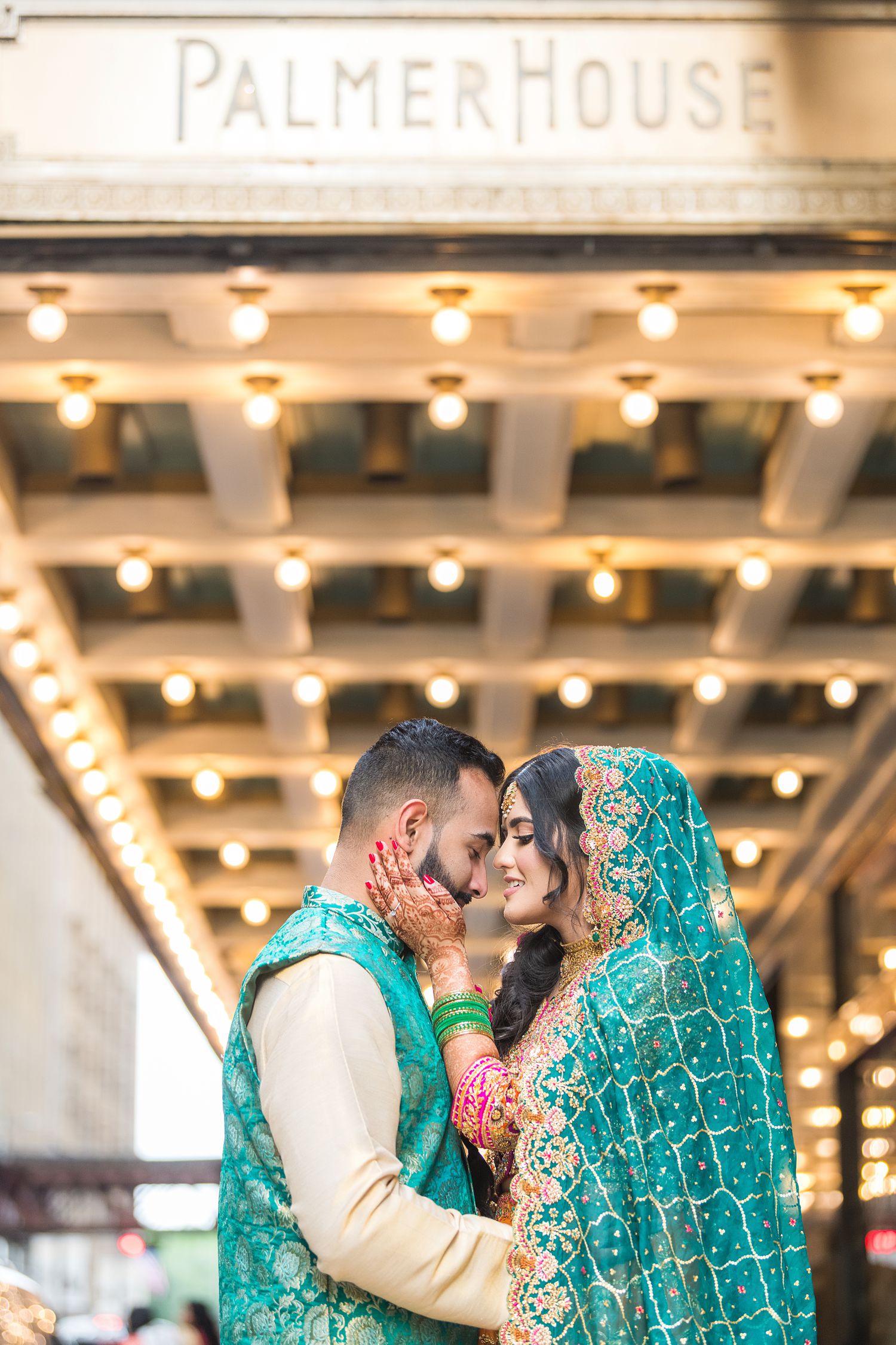 Teal Mehndi Outfit on Pakistani Bride and Groom portrait by Maha Studios at Palmer House Chicago