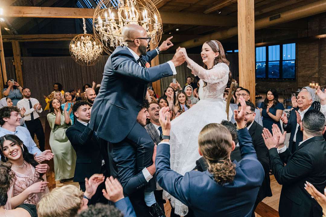 Wedding Couple dancing with their guests at the end of the night in the Skyline Loft of Bridgeport Arts Center. photographed by Maha Studios